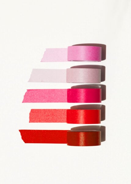 A row of red and pink tape on a white surface