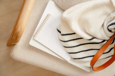 A white and black striped sweater sits on top of a chair