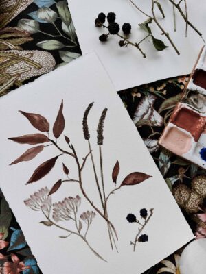 Watercolor painting of wildflowers and leaves