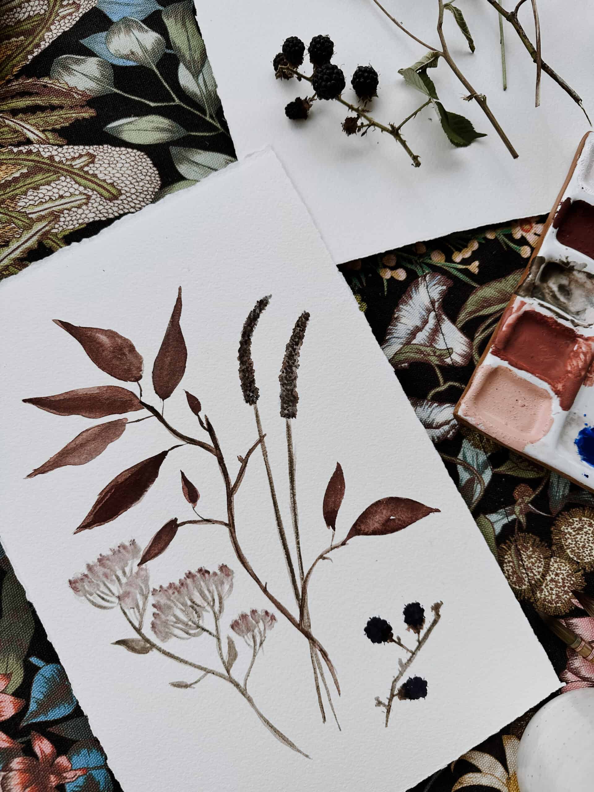 Watercolor painting of wildflowers and leaves